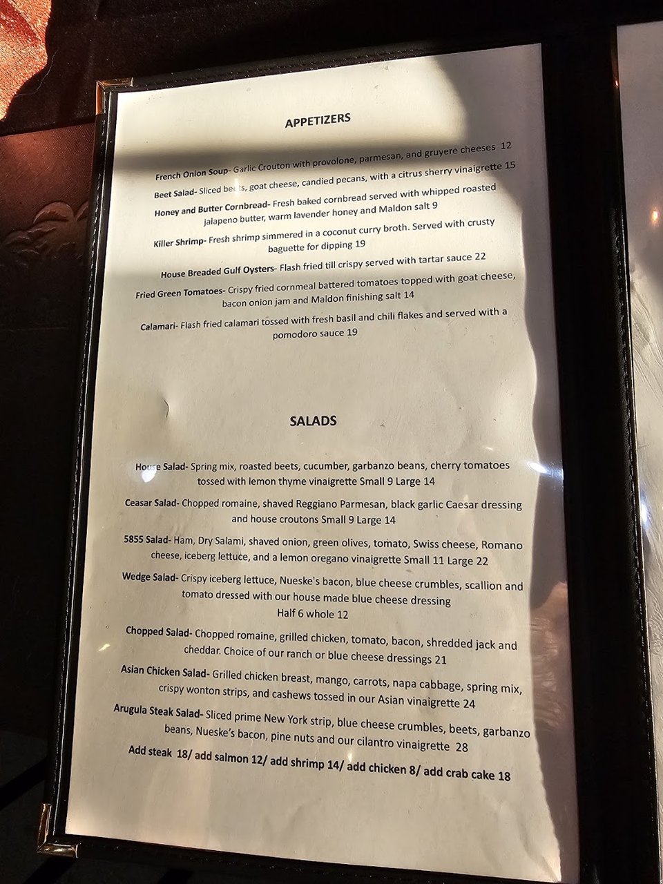 Printed menu for seafood, steaks, and burgers.